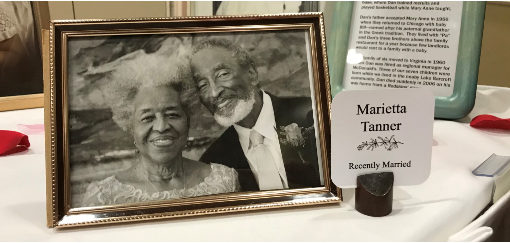 this is a photo of a wedding photo. In the wedding photo are two older African American people who are smiling on their wedding day