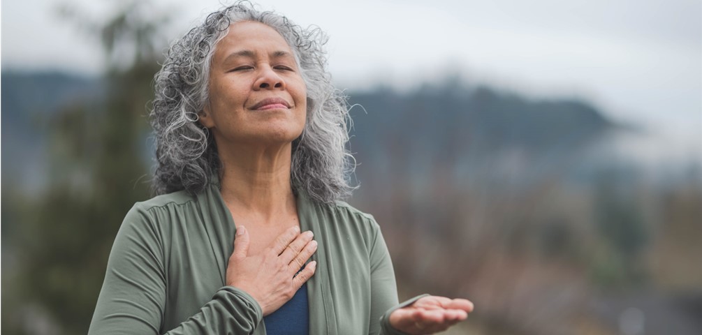 woman takes deep breath meditating