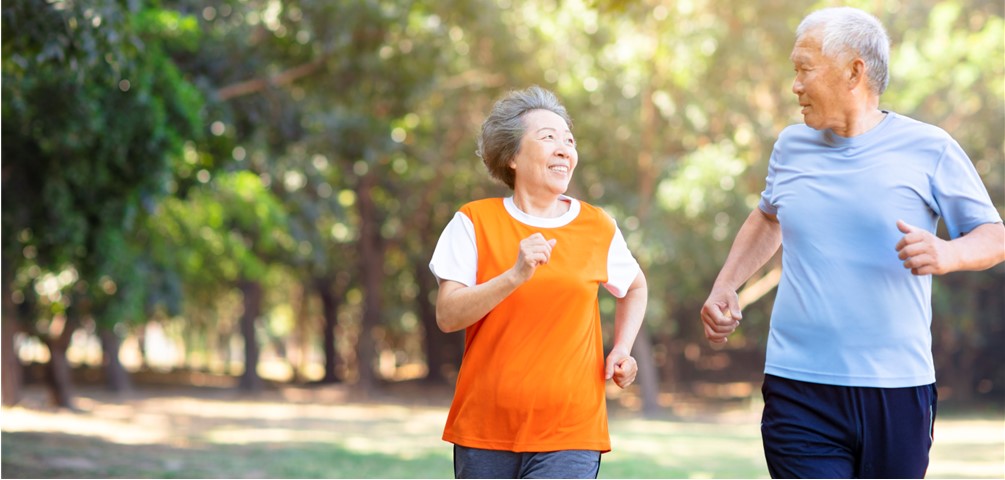 senior couple jog together outdoors in the summer
